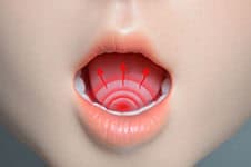 A close-up of a realistic doll's mouth with detailed lips and a visible tongue.