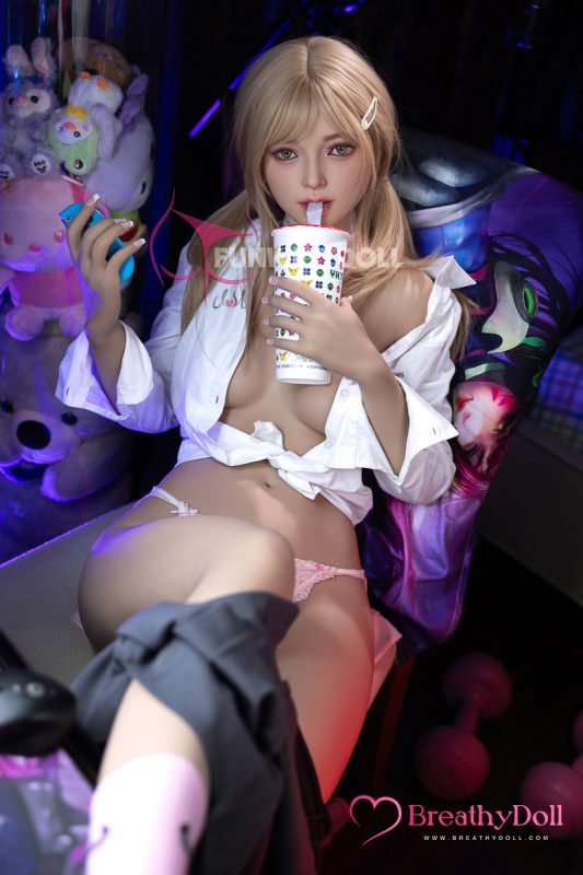 Blonde-haired realistic companion doll sipping soda with straw, wearing a partially unbuttoned white shirt and pink lace underwear, sitting in a colorful, plush toy-filled room for adult comfort and companionship portrayal.