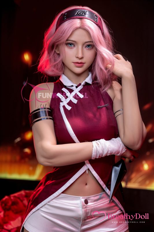 Styled anime-inspired doll with pink wavy hair, striking blue eyes, and a confident expression, wearing a detailed ninja costume with a red top, white shorts, and accessories.
