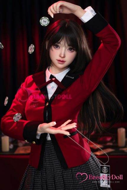 Realistic female companion doll with long dark hair, large expressive eyes, and a lifelike facial expression, dressed in a red and black schoolgirl outfit, posed against a dark background.