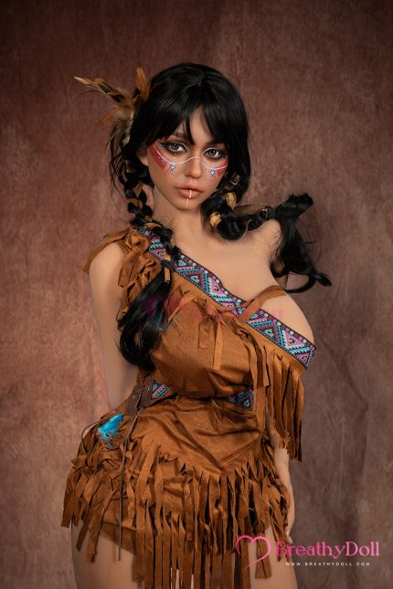 Stunning doll with long black hair styled in braids, adorned with feathers and traditional face paint.