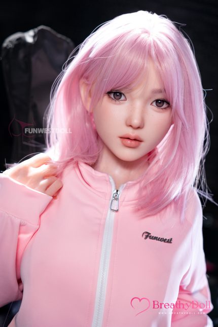 A close-up of a high-quality, realistic companion doll with pink hair and detailed facial features, dressed in a pastel pink jacket, emphasizing its lifelike look and intricate craftsmanship, ideal for collectors.