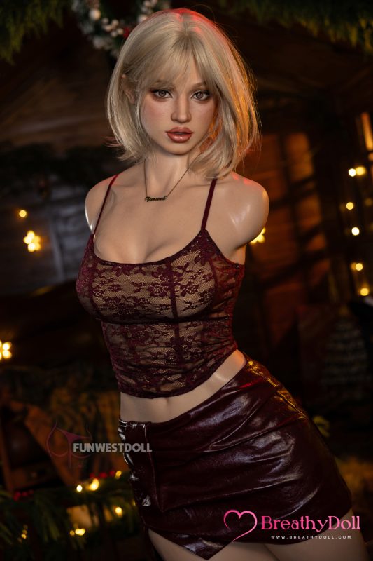 Young woman with blonde hair in a lace top and leather skirt, posing indoors with warm lighting.